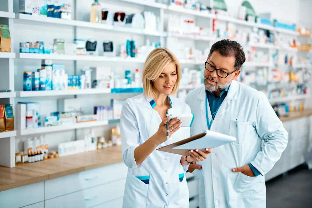 Female pharmacist and her mature colleague checking inventory while working in drugstore. - ADVance Care Pharmacy